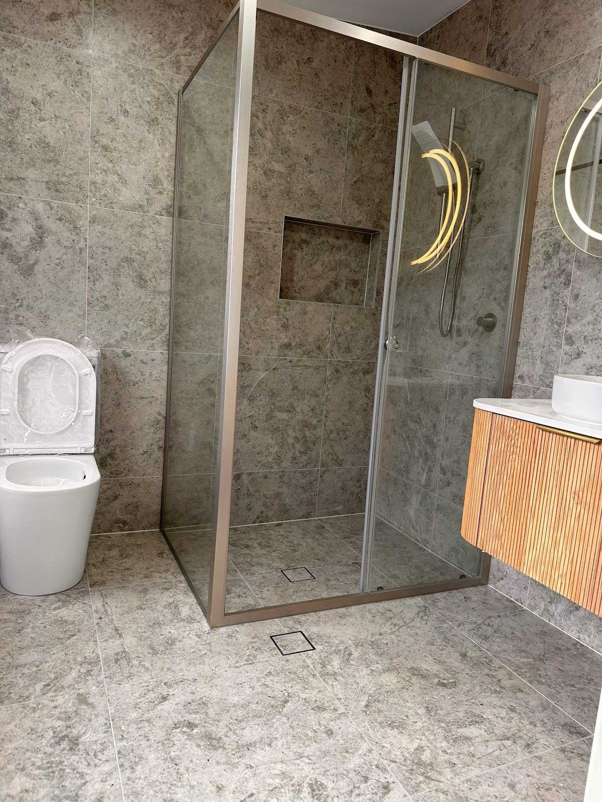 Frameless glass shower installation in a bathroom renovation