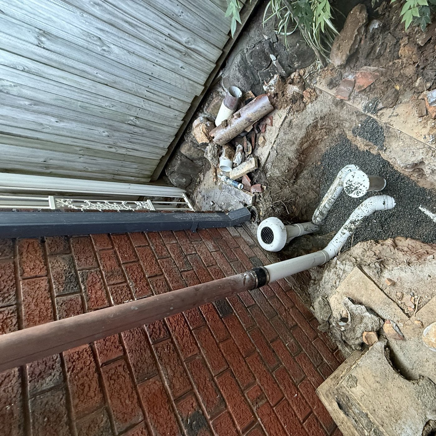 Drainage repair exposing pipework beneath a brick paved courtyard, Winston Hills