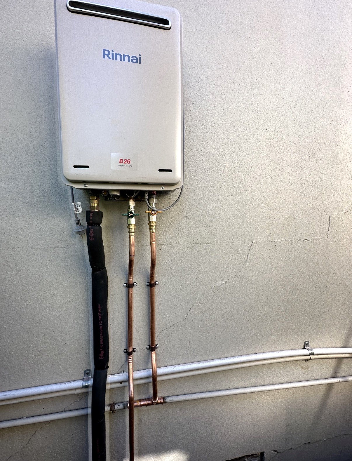 Rinnai continuous flow hot water system installed on an exterior wall, Seven Hills